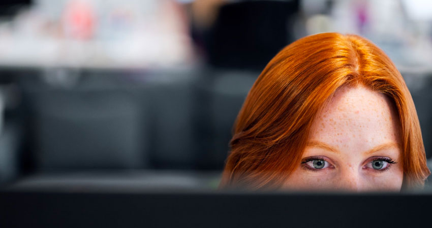 red-haired-woman-working-on-computer